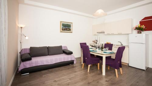 a living room with a table and a couch at Apartment Simone in Split