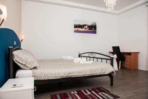 a small bedroom with a bed and a desk at Apartment Simone in Split