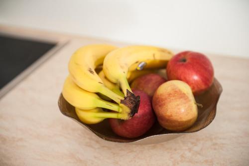 a bowl of fruit with apples and bananas at Apartment Simone in Split
