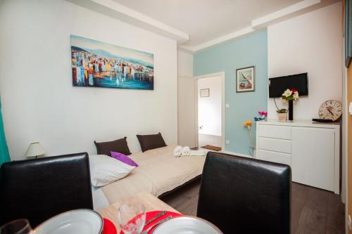 a living room with a bed and a couch at Apartment Simone in Split