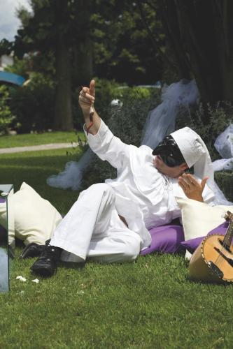 a man laying on the grass with his hand in the air at Hotel Ristorante La Piana in Telese