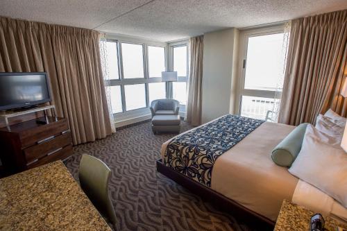 a hotel room with a bed and a television at Boardwalk Resorts - Flagship in Atlantic City