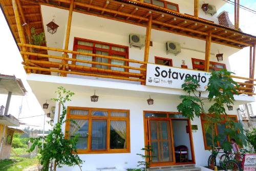 a building with a sign for a restaurant at Hotel Sotavento in Montañita