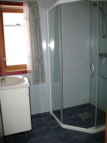 a bathroom with a shower and a sink at Seljestad Cottages in Skare