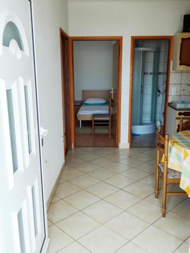 a room with a bedroom with a bed and a door at Apartment Anamaria in Pag
