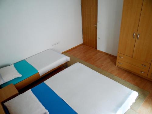 a small room with a bed and a closet at Apartment Anamaria in Pag