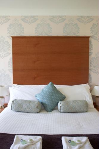 a bed with two pillows on top of it at Flackley Ash Country House Hotel in Rye
