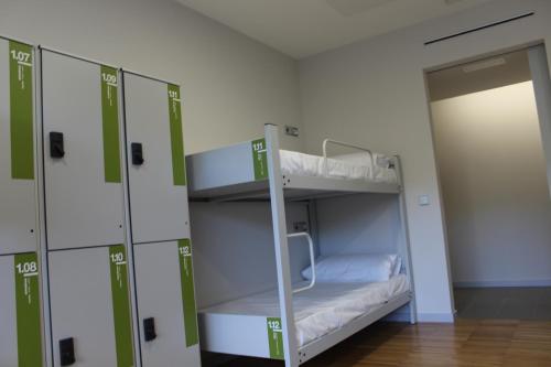 a room with two bunk beds and a door at Arantzazu Aterpetxea in Oñati