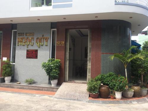 a building with potted plants in front of it at NGỌC QUÝ Mini House in Quy Nhon