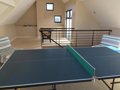 a ping pong table in the middle of a room at Huge House on the Grand Canal in Mandurah