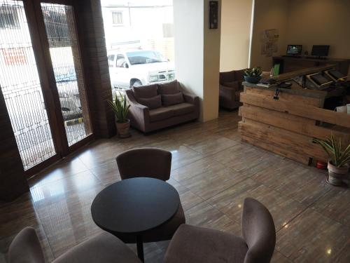 a living room with a table and chairs and a couch at Cebu R Hotel Mabolo in Cebu City