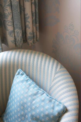 a blue pillow sitting on a chair in a room at Flackley Ash Country House Hotel in Rye