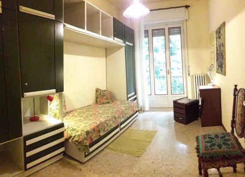 a bedroom with a bed and a large window at Stop and Go in Olgiate Comasco