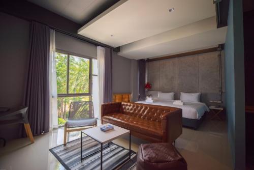 A bed or beds in a room at Wara Boutique Hotel