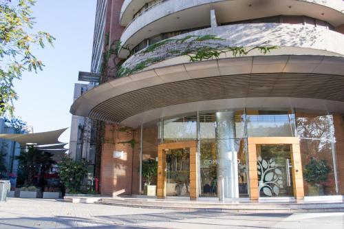 a building with a large glass window at Providencia Plaza in Santiago