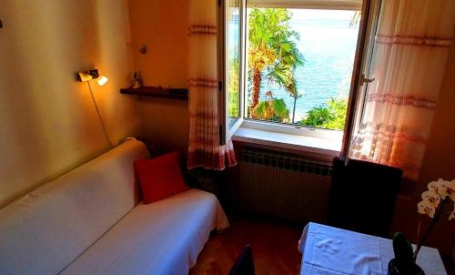 a room with a couch and a window with a view at Apartments Ida & Miljenko in Kaštela