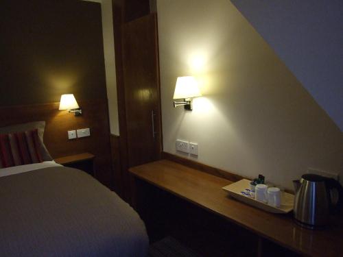 a hotel room with a bed and two lights on the wall at Leith House in Edinburgh