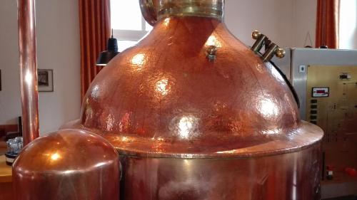 a large copper bottle sitting on top of a machine at FeWos im alten Bahnhof in Lauterecken