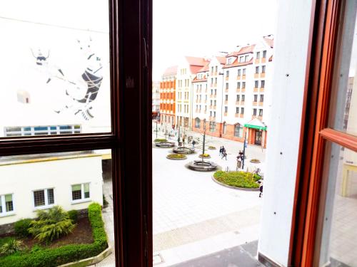 a view of a street from a window at City Central Hostel - Pokoje prywatne in Wrocław