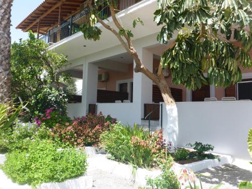 a house with a garden in front of it at Studios Resbithas in Gythio