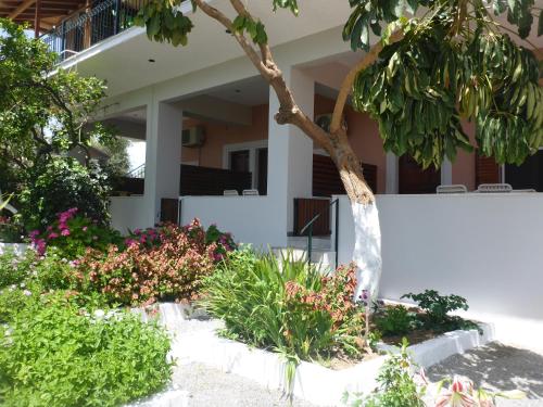 a house with a garden in front of it at Studios Resbithas in Gythio