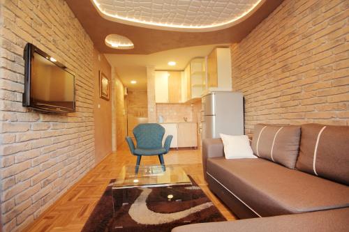 a living room with a couch and a chair at Apartments Belgrade in Belgrade