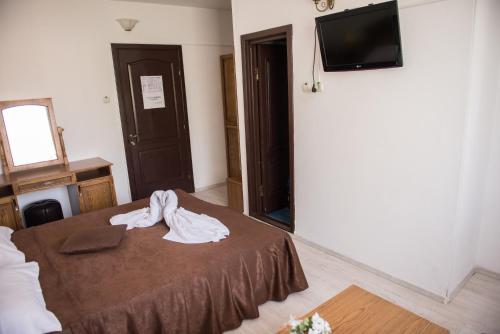 Ένα ή περισσότερα κρεβάτια σε δωμάτιο στο Hotel Dynes
