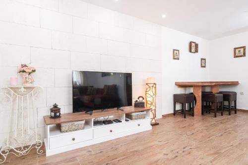 a living room with a television on a white entertainment center at Split Inn Apartments in Split