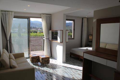 a hotel room with a bed and a large window at Yarden Estate Hotel in Yesod Hamaala