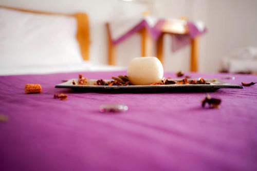 a plate of food with an egg on a purple table at Villa Xenia in Makry Gialos