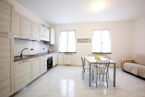 a kitchen with a table and chairs and a couch at Riviera Apartments in Levanto