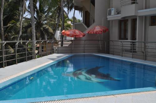 a shark swimming in a swimming pool at Marine Palace Beach Hotel in Kovalam