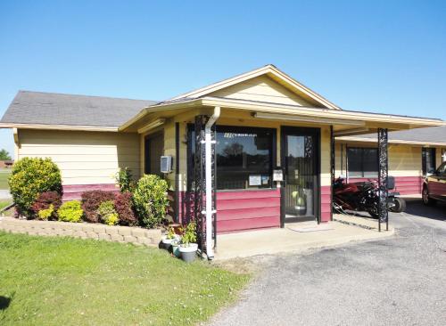 a house with pink and purple doors on it at Relax Inn Vinita in Vinita