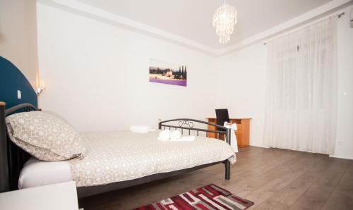 a bedroom with a bed and a chandelier at Apartment Simone in Split
