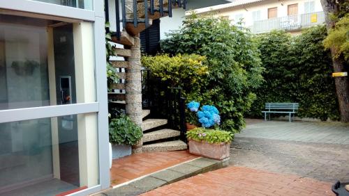 a stairway with blue flowers next to a building at Residence Al Lago in Castiglione del Lago