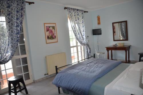 a bedroom with a bed and a large window at Il Grifo in Sabaudia