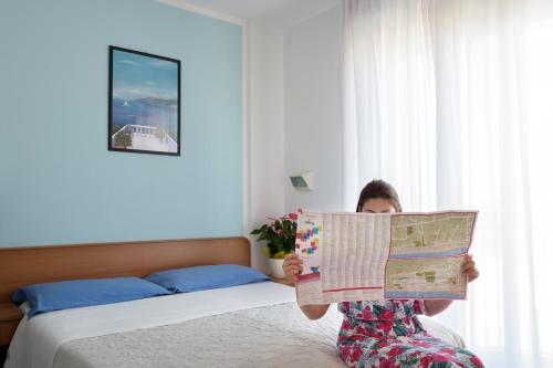 Postel nebo postele na pokoji v ubytování Hotel Emilia