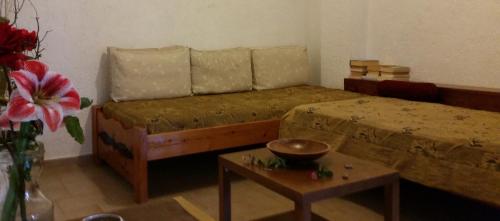 a bedroom with a bed and a table with a bowl on it at Villa Xenia in Makry Gialos