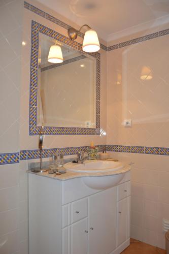 a bathroom with a sink and a mirror at Apartment Peniche swimming pool in Peniche de Cima