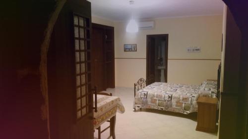 a room with two beds and a door to a bedroom at Villa Laura Apartment in Giardini Naxos