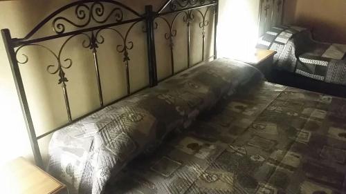a bed in a bedroom with a metal frame at Villa Laura Apartment in Giardini Naxos