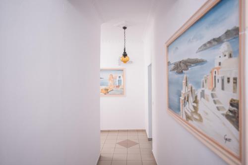 a hallway with a large painting on the wall at Hotel Olympia in Karterados