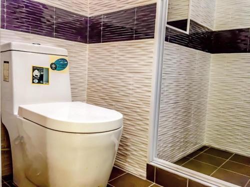 a bathroom with a toilet and a shower at Tropical Garden Studio in Pattaya South