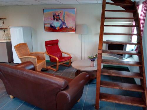 a living room with a couch and chairs and a ladder at Langs De Maas in Boxmeer