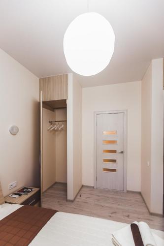 a bedroom with a bed and a large light fixture at Apartments near Deribasovskaya in Odesa