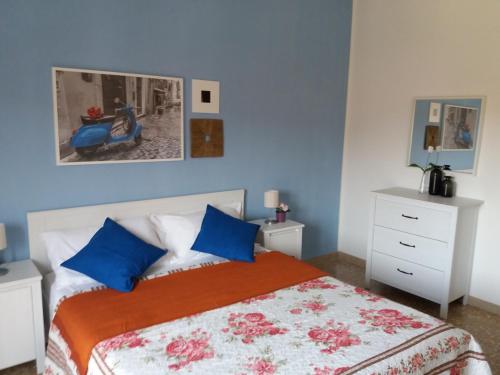 a bedroom with a bed with blue walls at Near To Pisa Airport Guesthouse in Pisa