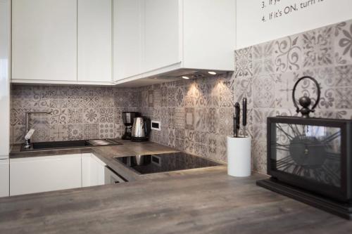 a kitchen with white cabinets and a counter top at Sleep Split in Split