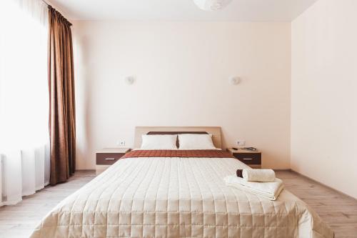 a bedroom with a large bed and a large window at Apartments near Deribasovskaya in Odesa