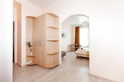 a room with a wooden cabinet and a bedroom at Apartments near Deribasovskaya in Odesa