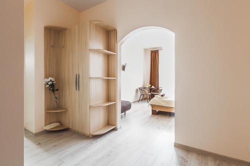 a hallway with a room with a bed and a table at Apartments near Deribasovskaya in Odesa